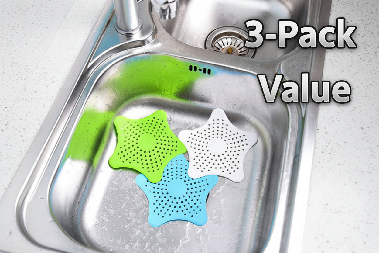 Star-shaped silicone sink strainers in green, white, and blue on a kitchen sink.